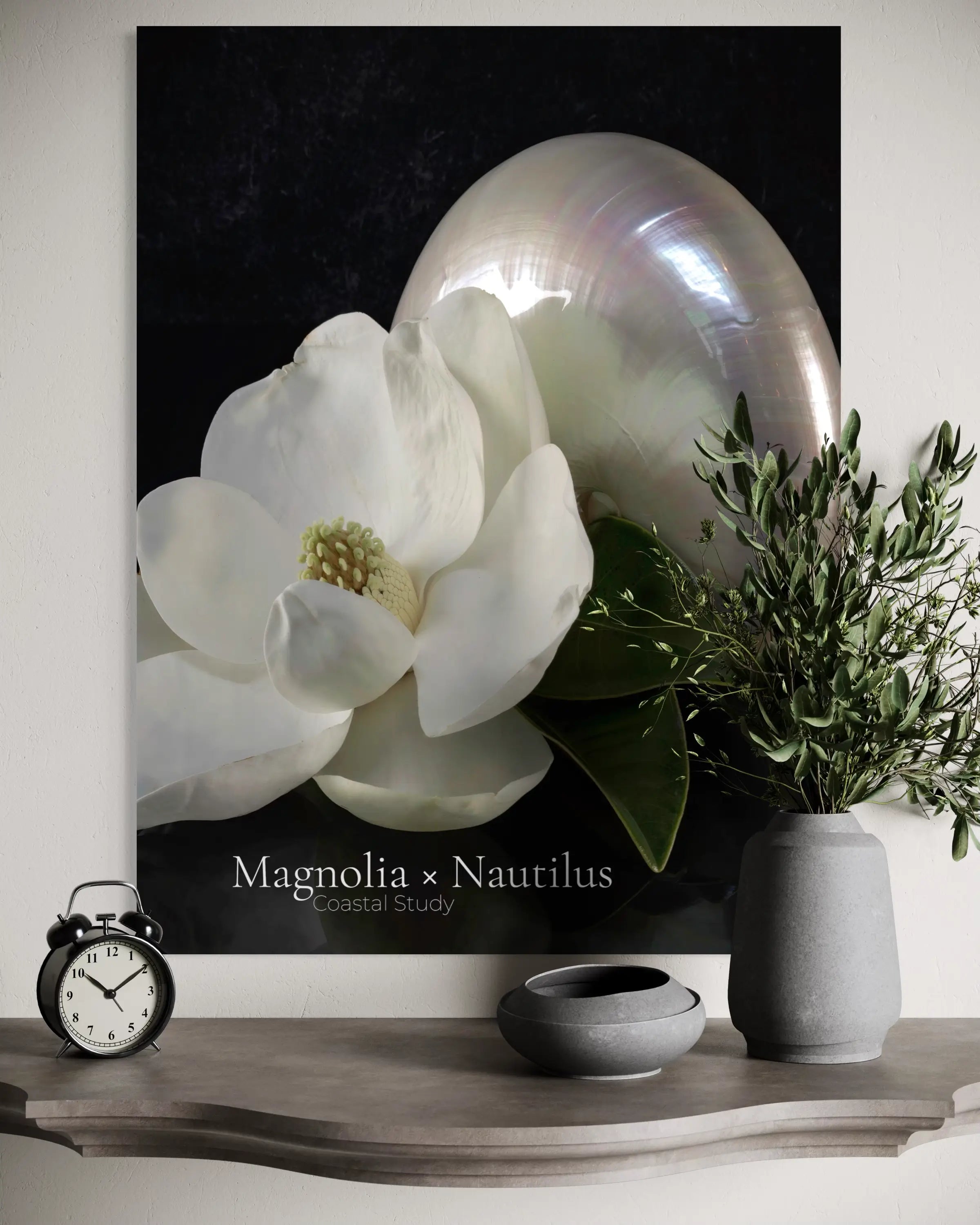 Magnolia and nautilus shell glass wall art styled above console with vase and decor accents