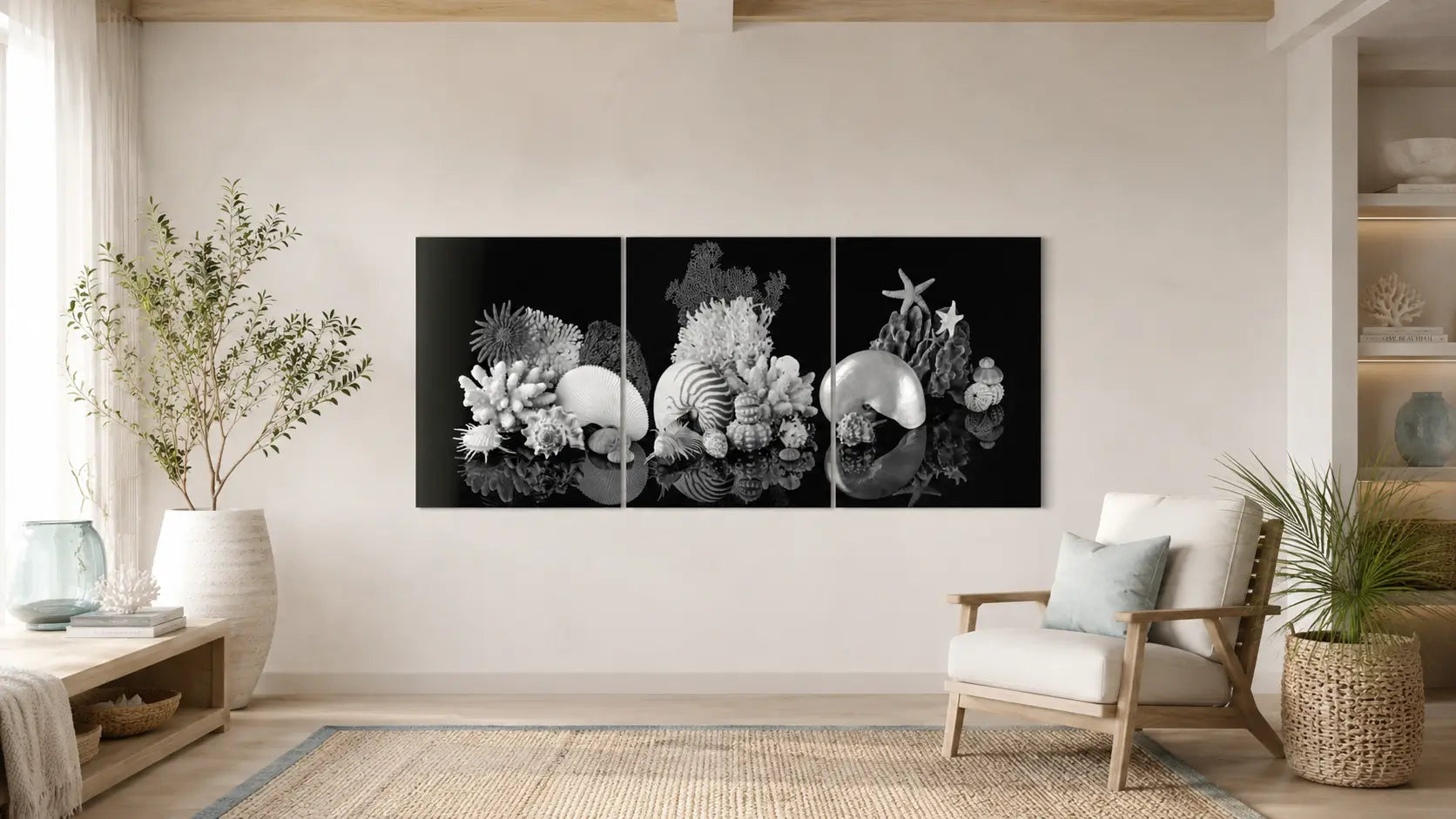 Three-panel black-and-white nautilus shell artwork displayed in a bright coastal interior with natural wood and neutral furnishings.