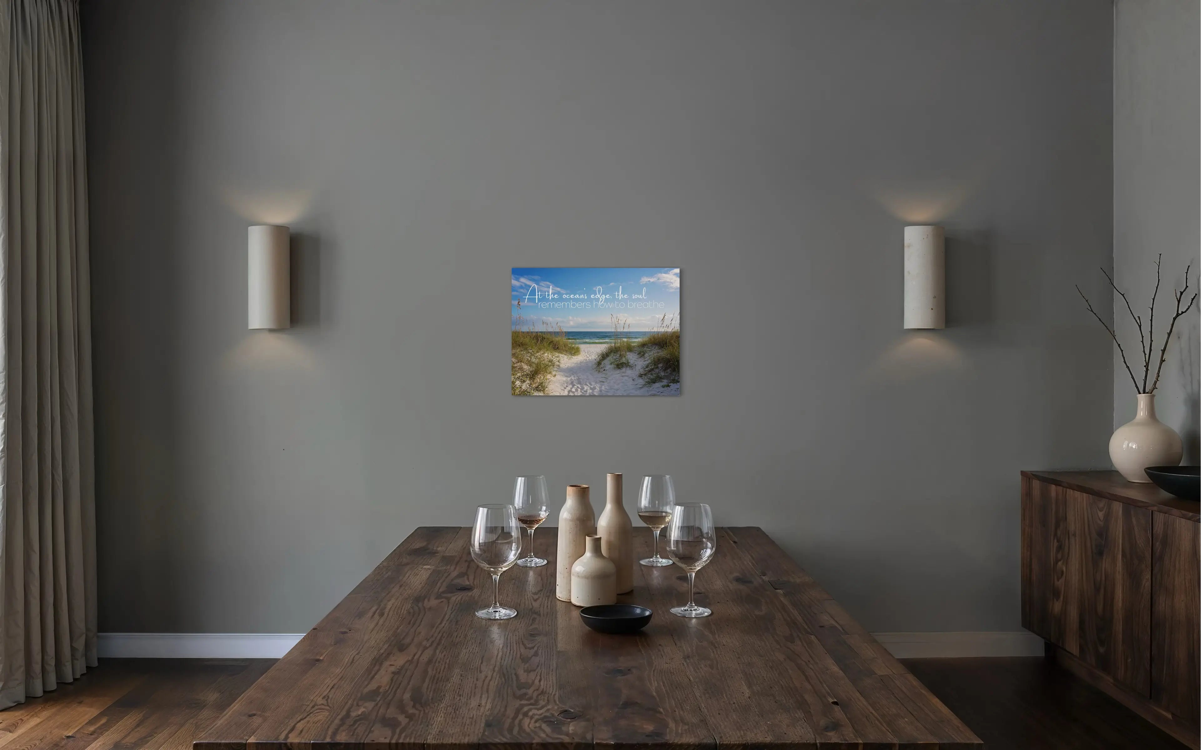 Coastal glass print with inspirational quote: At the ocean’s edge, the soul remembers how to breathe. Sand dunes and sea oats, coastal dining room