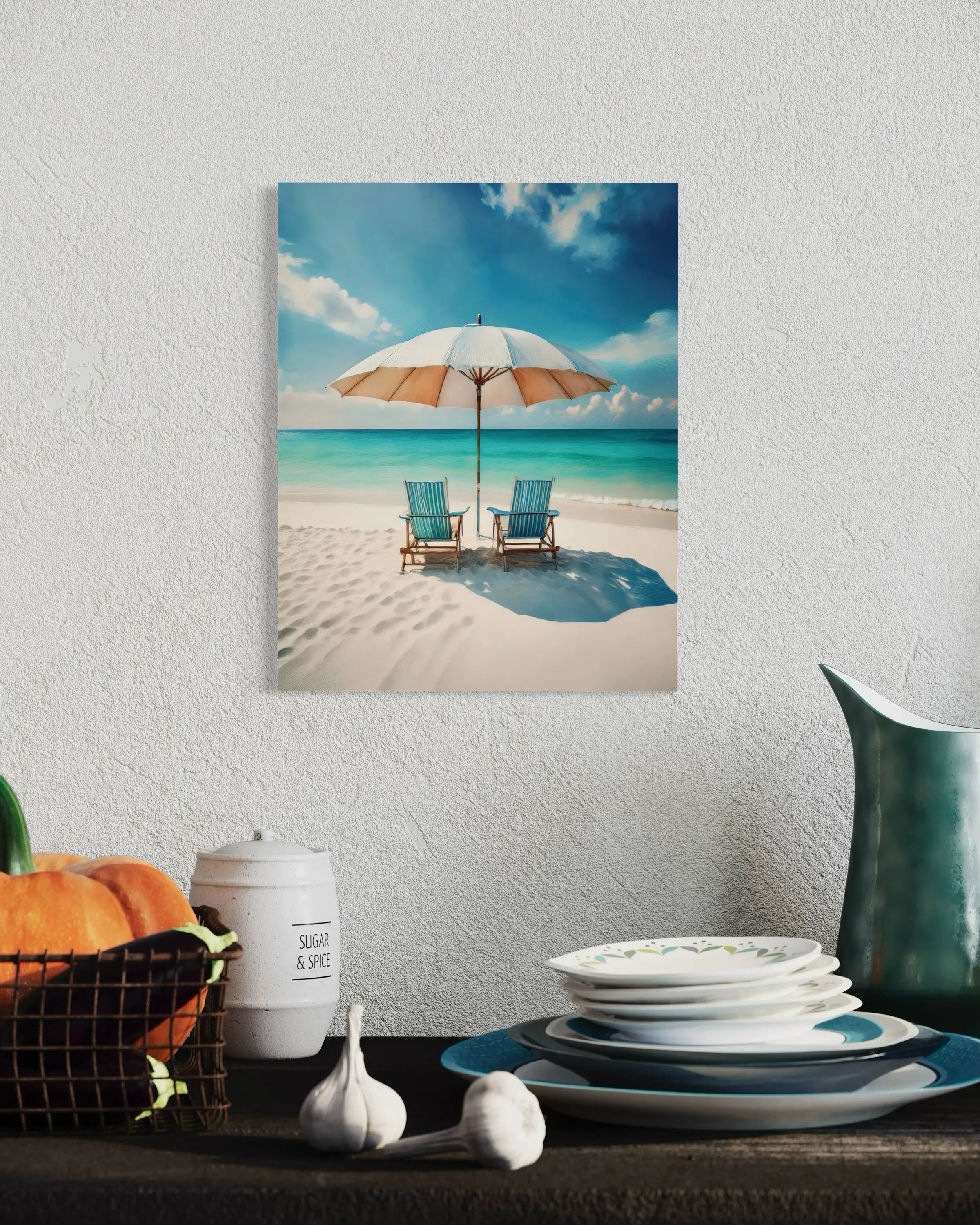 Beach scene with umbrella and chairs glass print on a wall above a table with decorative items.
