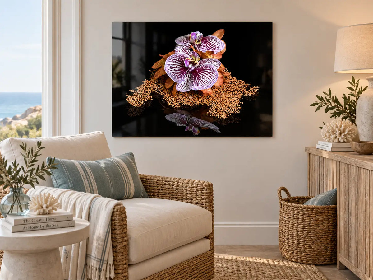 Sea fan and orchid glass print displayed in a bright coastal sitting nook with natural textures.