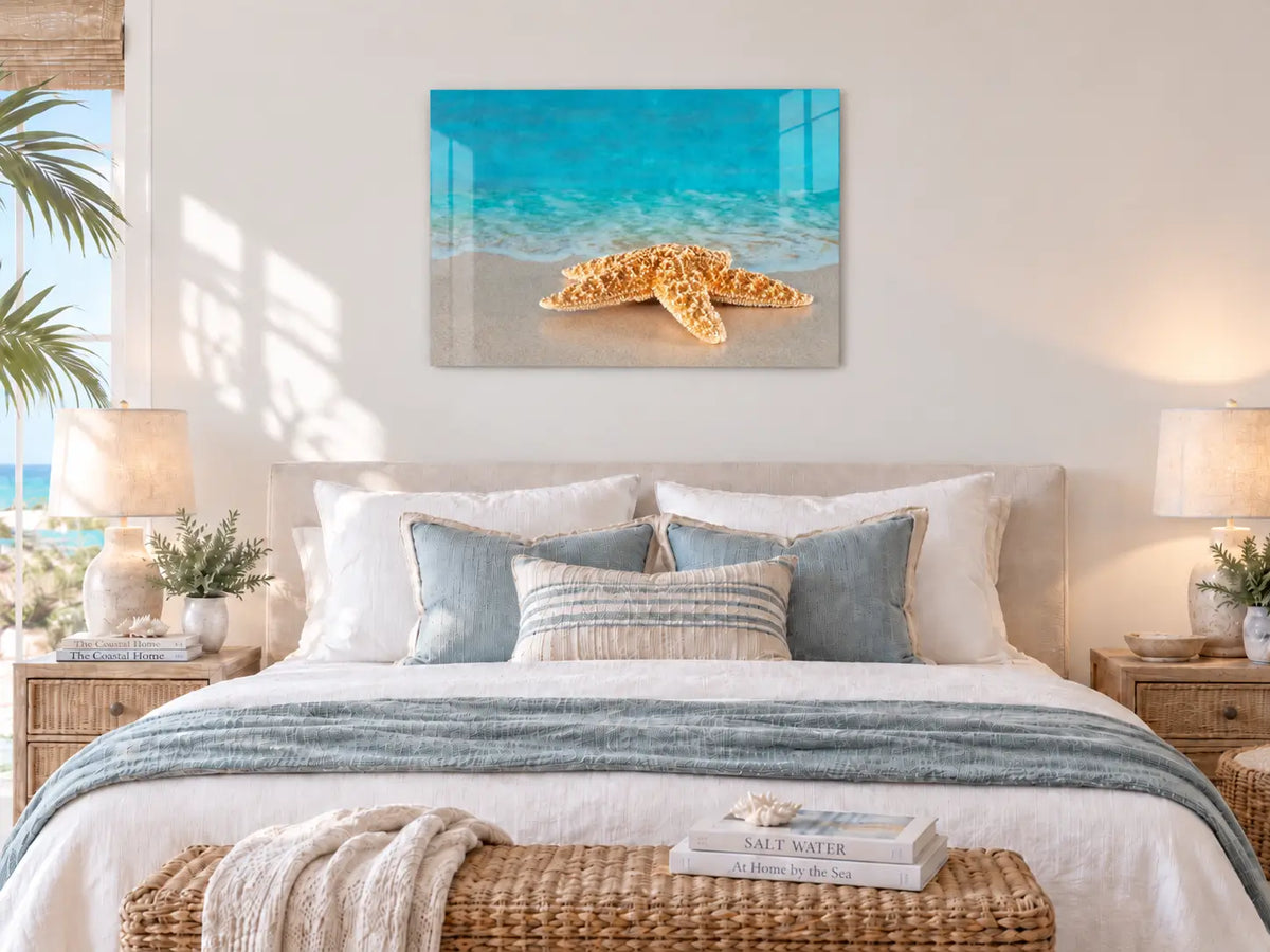 Starfish beach glass print displayed above a bed in a serene coastal bedroom.