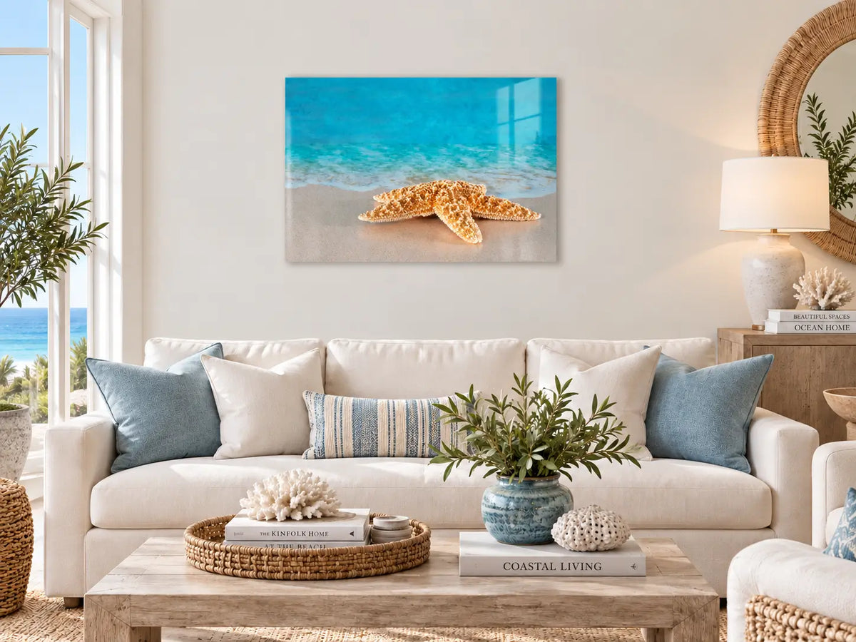 Starfish beach wall art displayed above a sofa in a bright coastal living room.