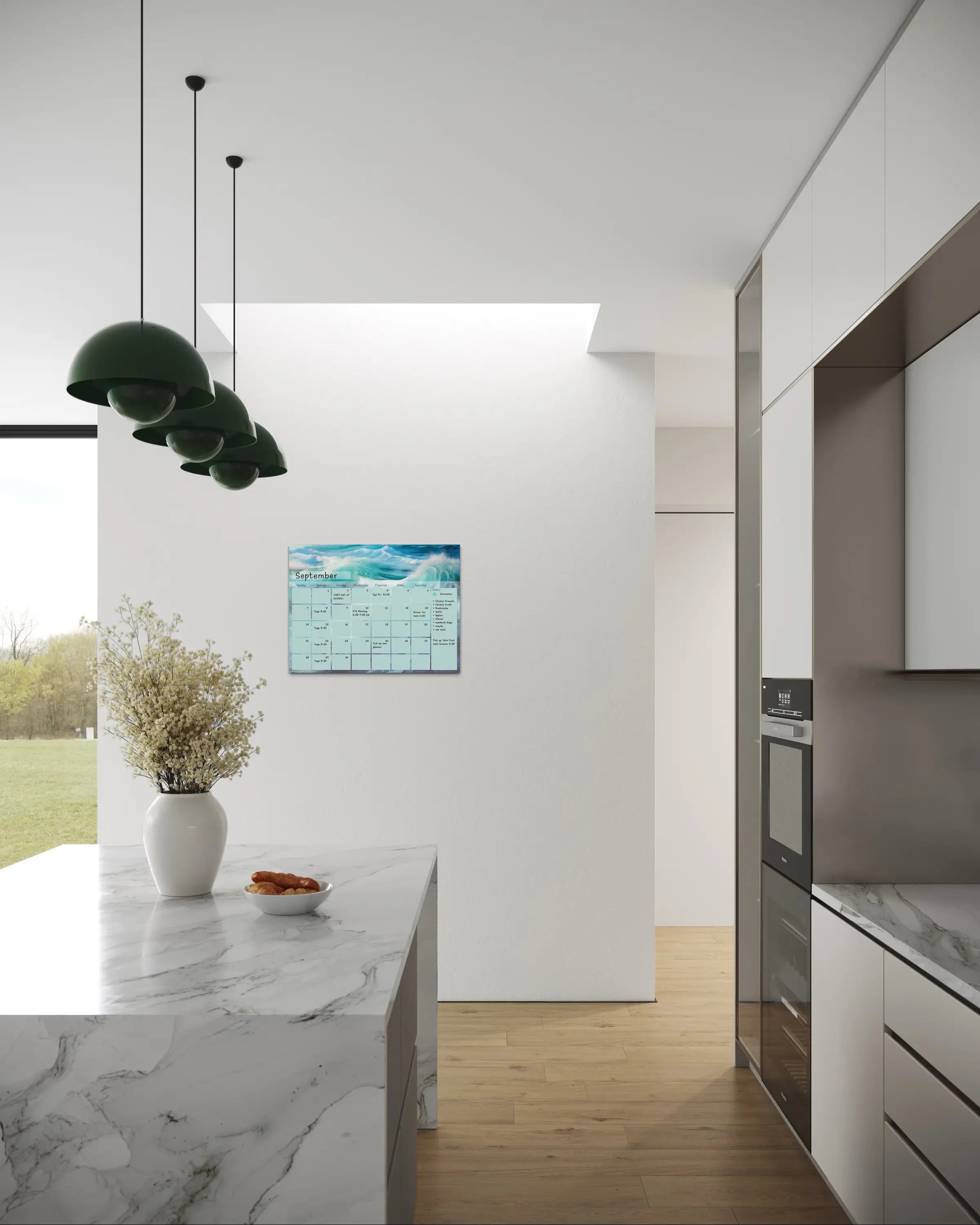 A dry-erase perpetual glass calendar with teal and blue ocean wave, showing the monthly grid and notes section for a sustainable home and office. Coastal kitchen