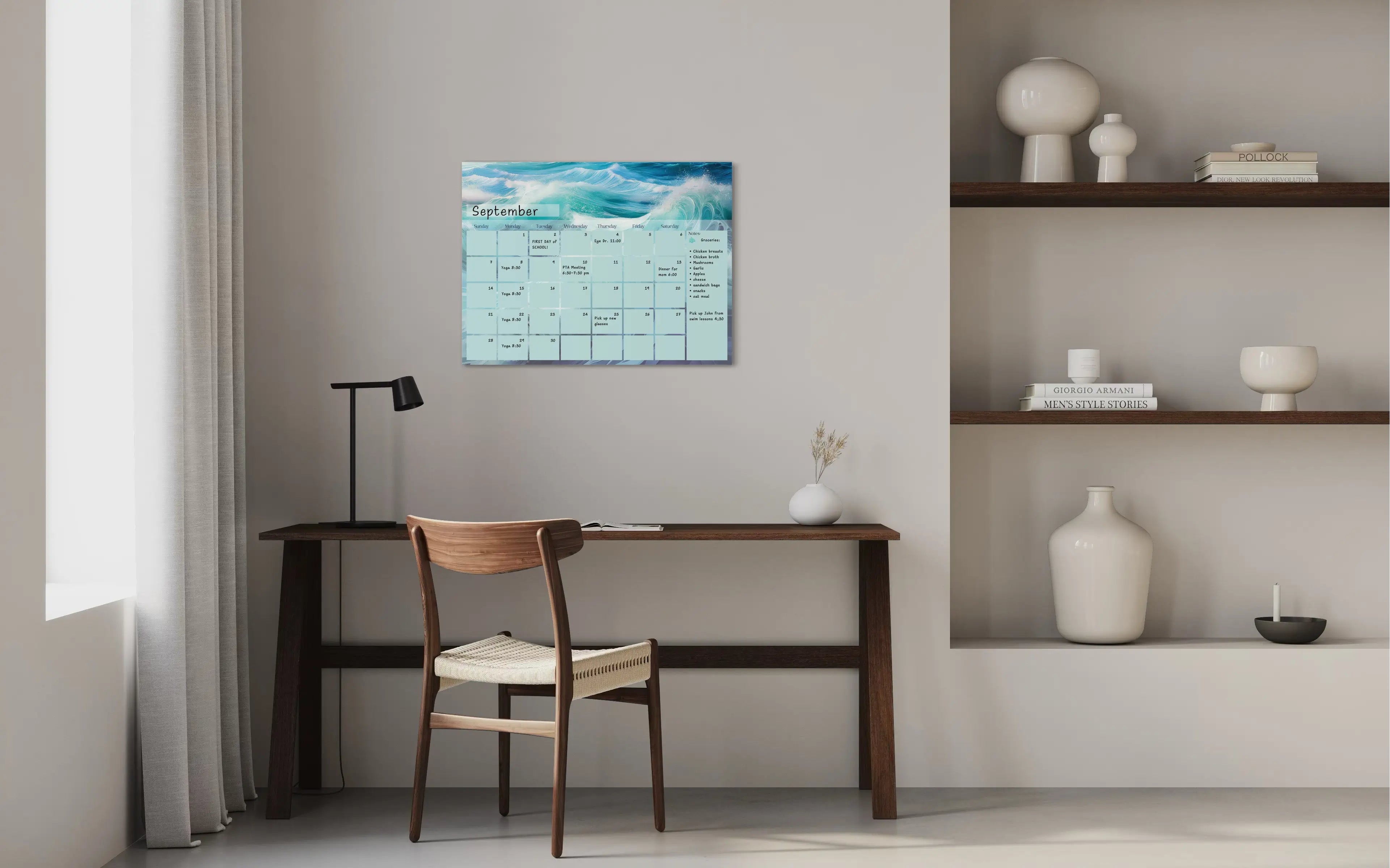 A dry-erase perpetual glass calendar with teal and blue ocean wave, showing the monthly grid and notes section for a sustainable home and coastal office.