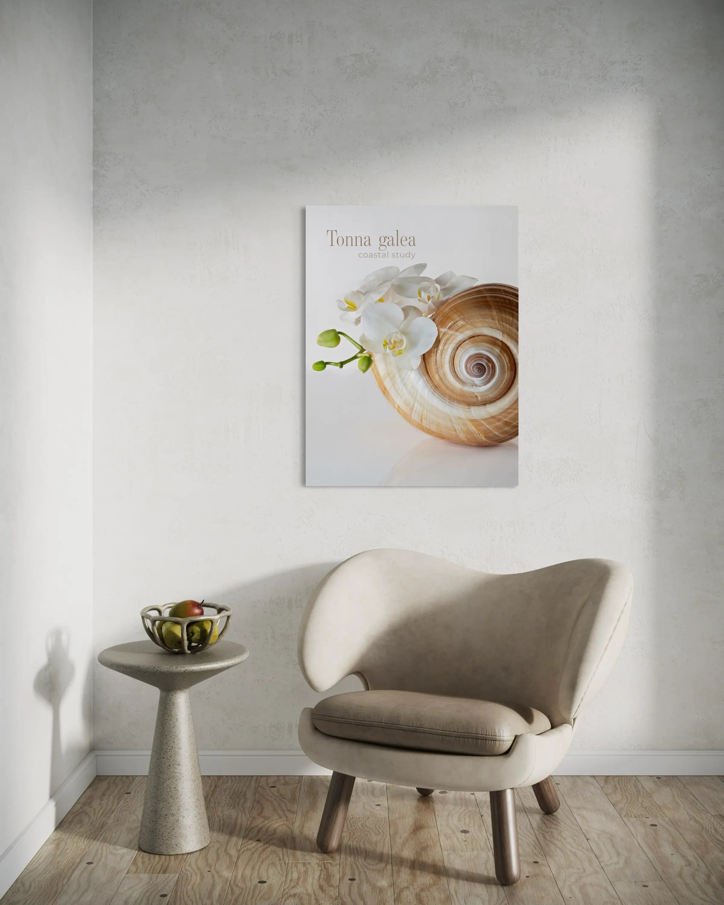 Tonna shell and white orchid glass wall art styled above a modern chair in a minimal coastal-inspired interior.