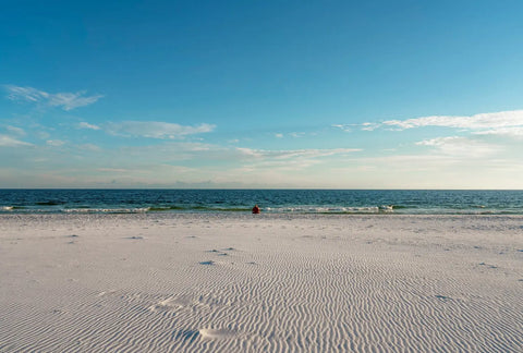 White sandy beach with rippled patterns, perfect for beach meditation and mindfulness.