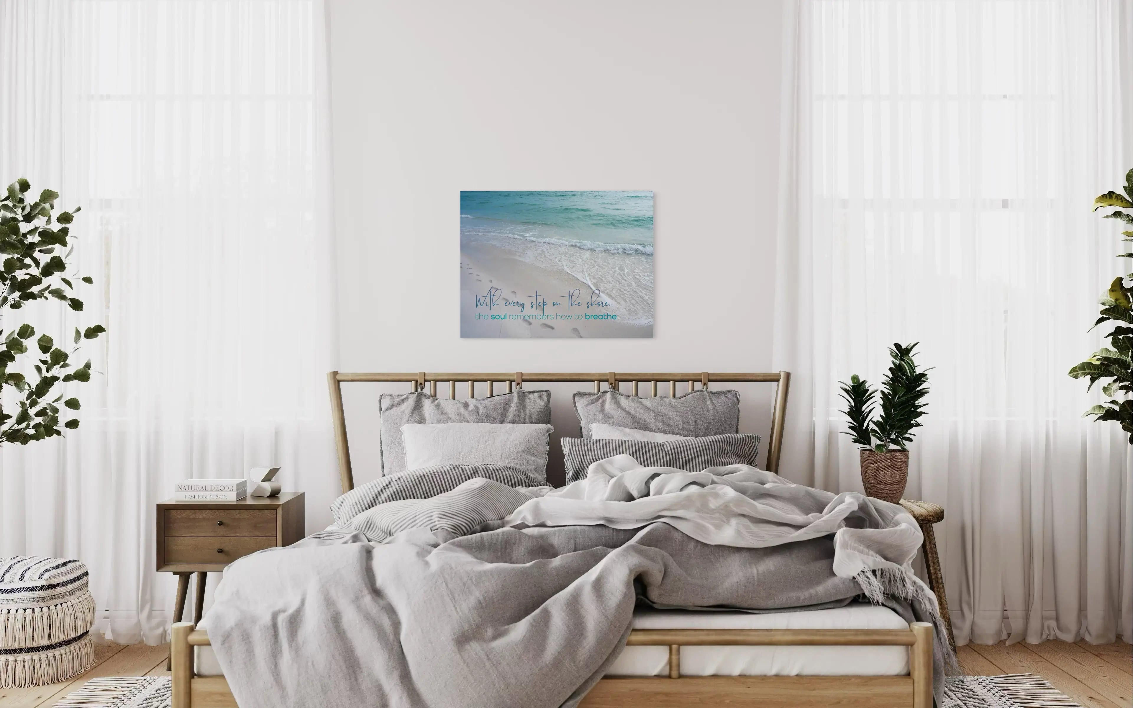 Coastal glass print with beach footprints and ocean waves. Quote reads: “With every step on the shore, the soul remembers how to breathe.coastal bedroom