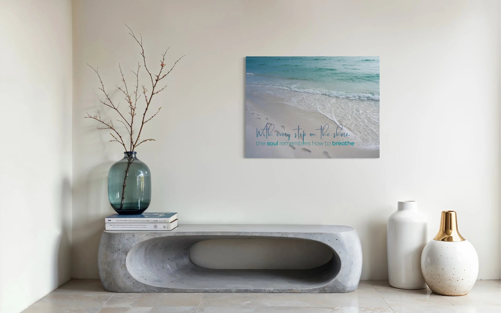 Coastal glass print with beach footprints and ocean waves. Quote reads: “With every step on the shore, the soul remembers how to breathe. modern inspirational ocean wall art.